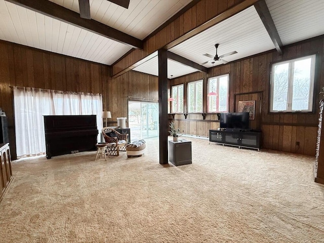 living room with ceiling fan, carpet, and beam ceiling