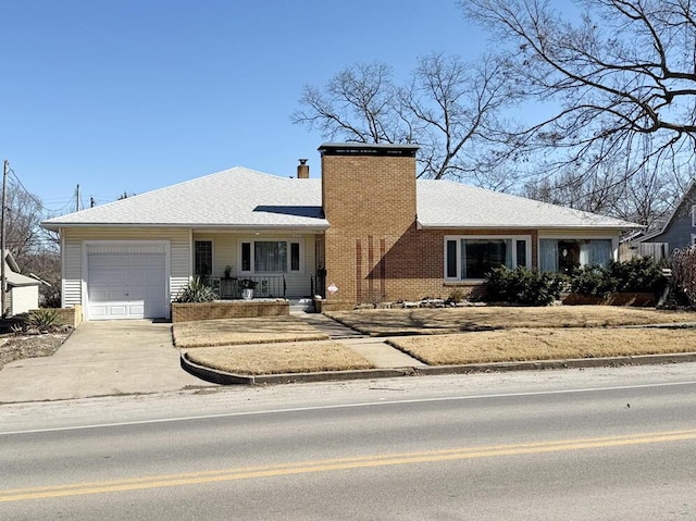 ranch-style home with a garage, driveway, a shingled roof, a chimney, and brick siding