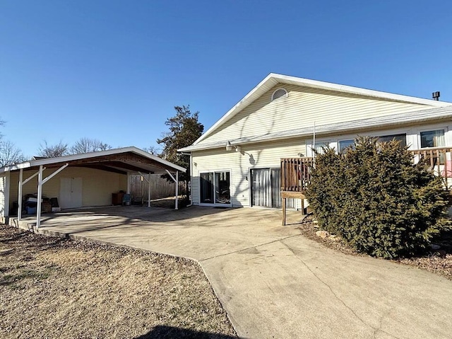 back of property with a carport and driveway