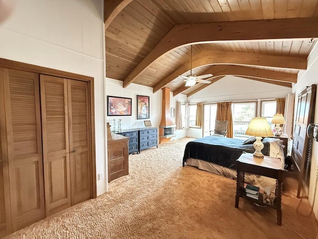 carpeted bedroom with vaulted ceiling with beams, ceiling fan, a closet, and wooden ceiling