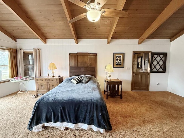 carpeted bedroom featuring lofted ceiling with beams, wooden ceiling, and a ceiling fan