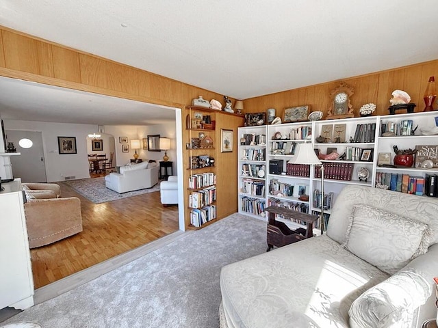 sitting room with wood walls and carpet