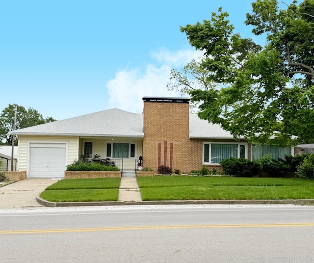 view of front facade with a garage, concrete driveway, a front lawn, and a chimney