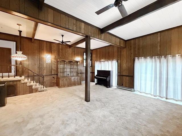 405 N Main St, El Dorado Springs, MO 64744 - unfurnished living room featuring a ceiling fan, beamed ceiling, wood walls, and carpet