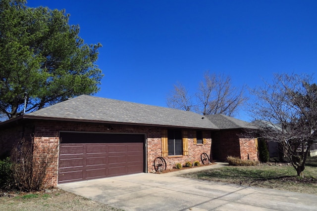 ranch-style home with a garage, driveway, a shingled roof, and brick siding