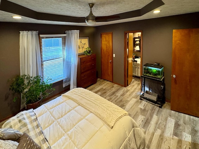 bedroom featuring light wood-style flooring, recessed lighting, and a textured ceiling