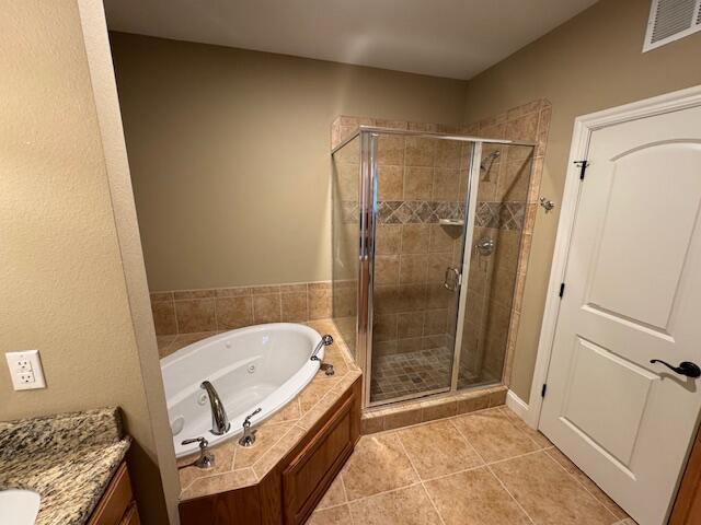 bathroom featuring visible vents, a tub with jets, tile patterned floors, vanity, and a shower stall