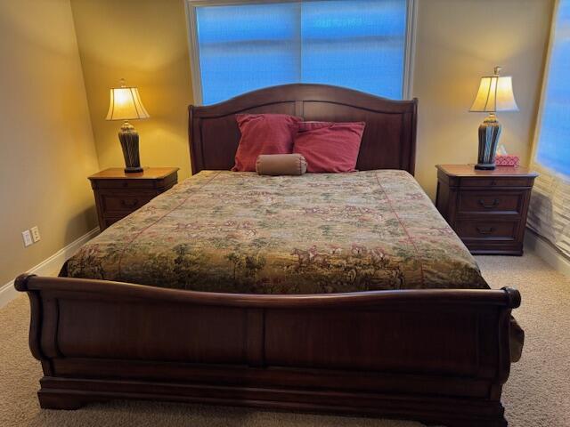 carpeted bedroom featuring baseboards