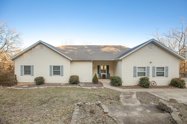 ranch-style house featuring roof with shingles