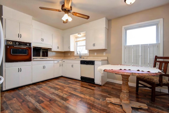 kitchen with a sink, light countertops, dishwasher, and oven