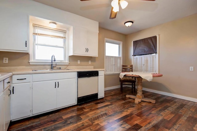 kitchen featuring white cabinets, light countertops, dishwasher, and a sink