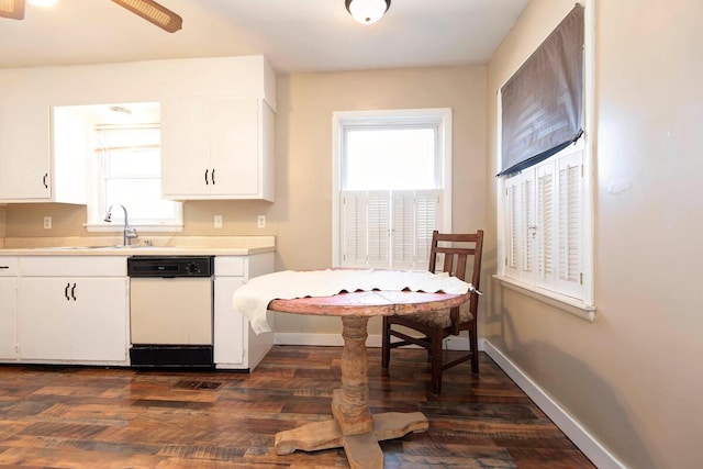 kitchen with a wealth of natural light, light countertops, dishwasher, and white cabinetry