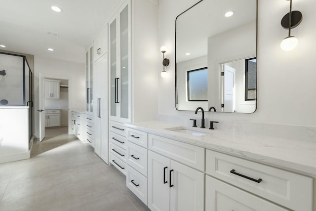 bathroom with a stall shower, a closet, vanity, and recessed lighting