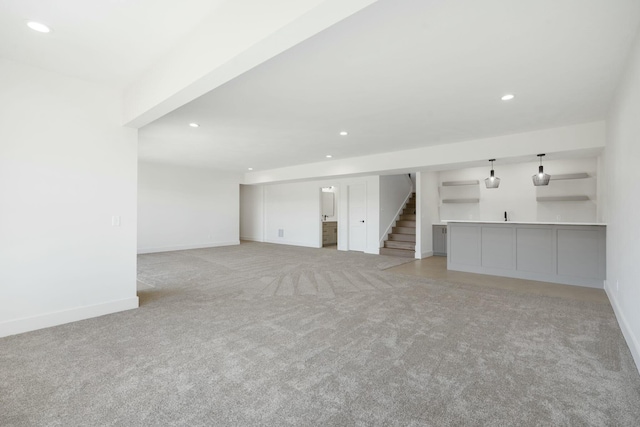 unfurnished room with baseboards, stairway, light colored carpet, and recessed lighting