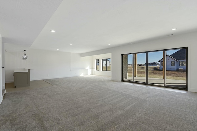 unfurnished living room with baseboards, carpet floors, and recessed lighting