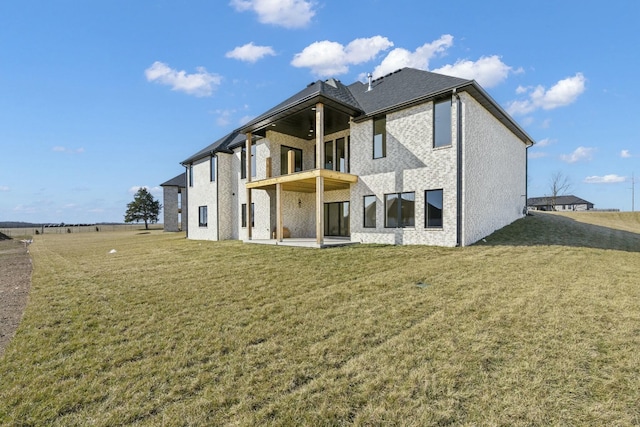 rear view of property featuring a lawn