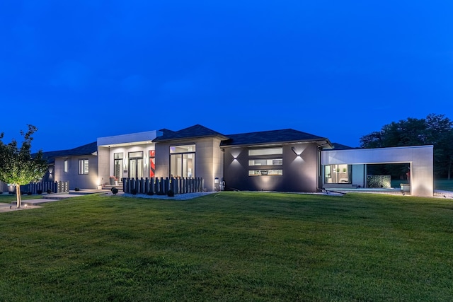 view of front of house with a front lawn and stucco siding