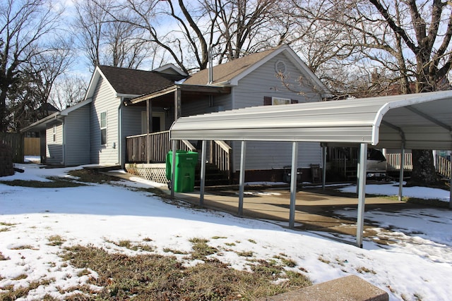 exterior space featuring a shingled roof and a detached carport