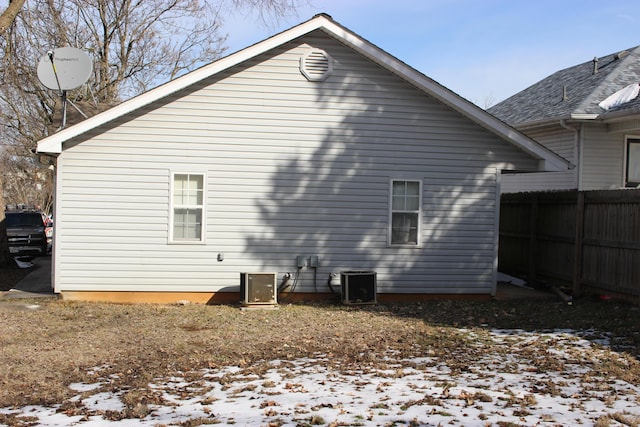 810 W College St, Springfield, MO 65806 - snow covered back of property with central AC and fence