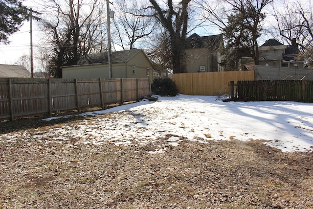 810 W College St, Springfield, MO 65806 - snowy yard featuring a fenced backyard