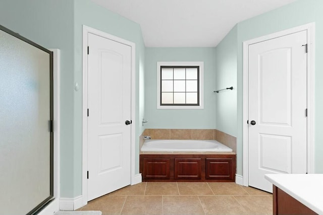 bathroom with a stall shower, tile patterned flooring, vanity, and a bath