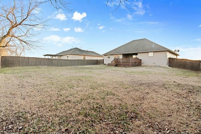 view of yard with a fenced backyard and a deck