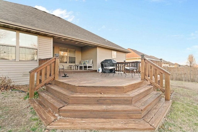 wooden deck with fence and area for grilling