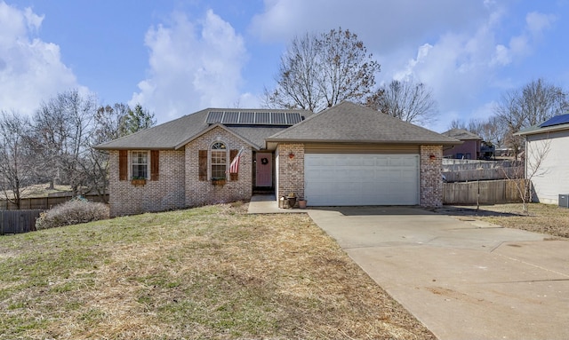 single story home with driveway, brick siding, and fence