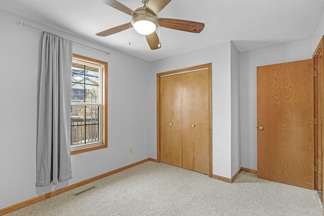 unfurnished bedroom with a closet, carpet flooring, and baseboards