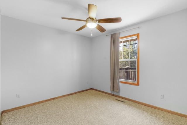 empty room with a ceiling fan, carpet, visible vents, and baseboards