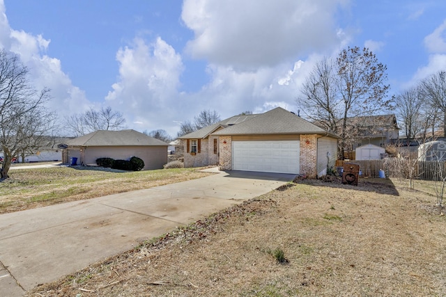 ranch-style home with an attached garage, roof with shingles, concrete driveway, and brick siding