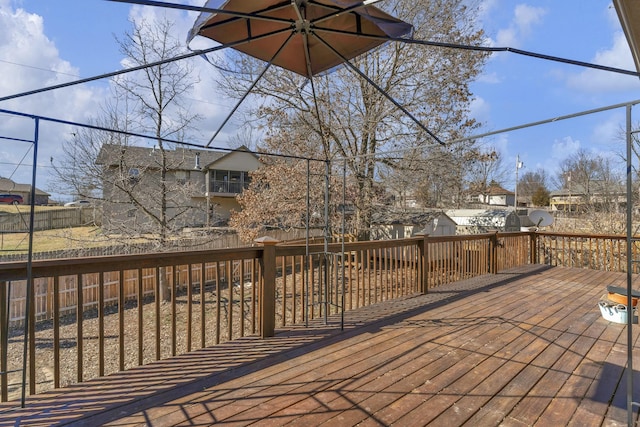 wooden terrace featuring an outbuilding