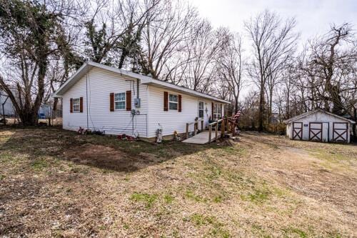 view of side of property with an outdoor structure