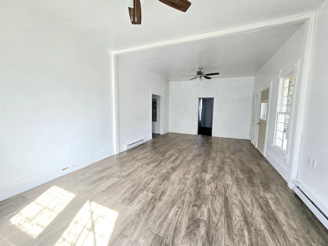 unfurnished living room featuring a ceiling fan, baseboard heating, and wood finished floors