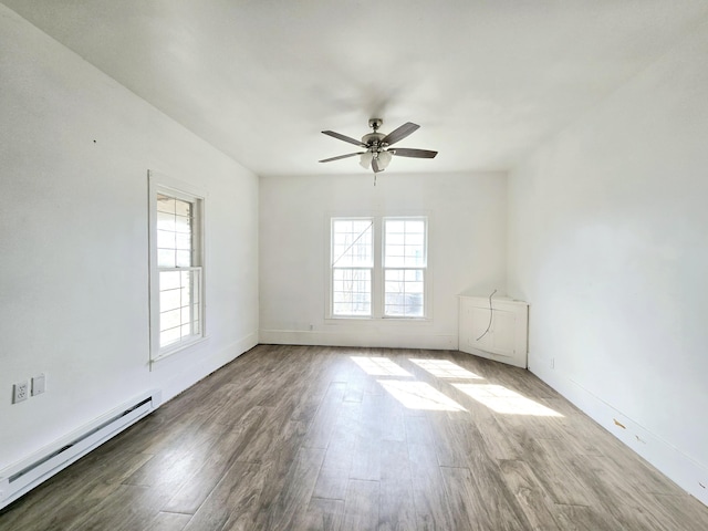 unfurnished room with a ceiling fan, a baseboard radiator, plenty of natural light, and wood finished floors