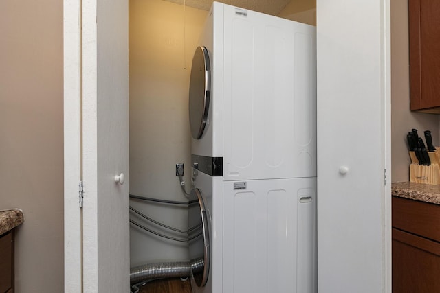 interior space with stacked washing maching and dryer