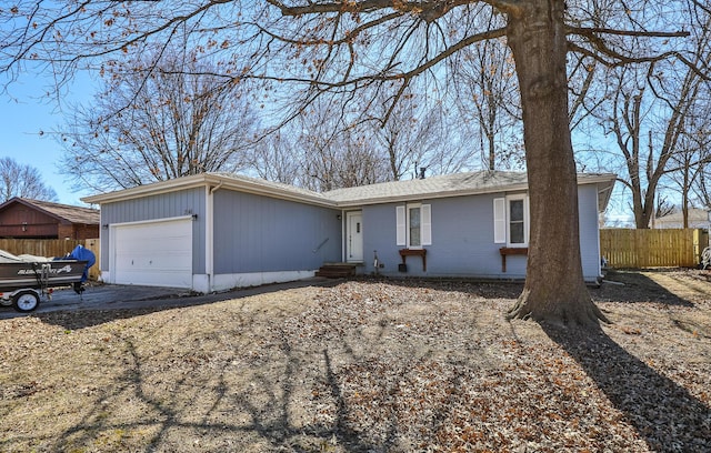 ranch-style house featuring brick siding, an attached garage, and fence