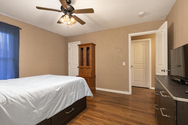 bedroom featuring ceiling fan, baseboards, dark wood finished floors, and a textured ceiling