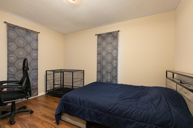 bedroom featuring a textured ceiling and wood finished floors