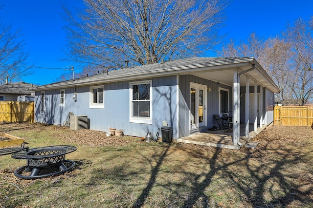 rear view of house featuring a yard, a patio area, fence, and central air condition unit