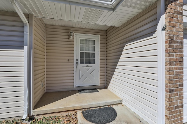 doorway to property featuring brick siding