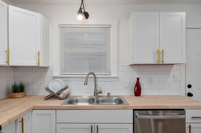 kitchen featuring dishwasher, backsplash, a sink, and wooden counters