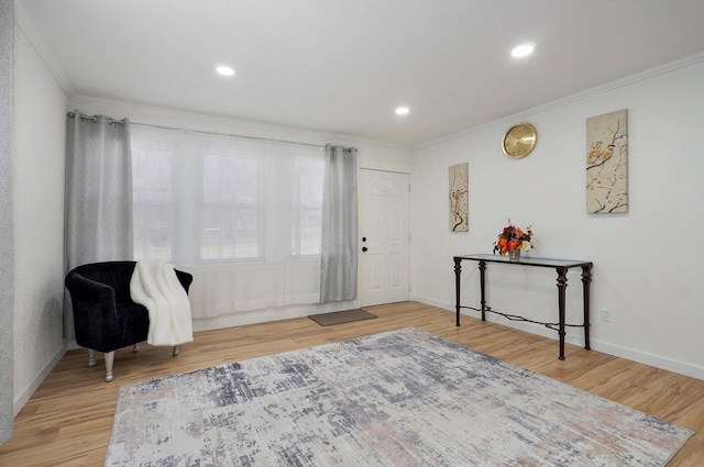 entryway featuring baseboards, ornamental molding, wood finished floors, and recessed lighting