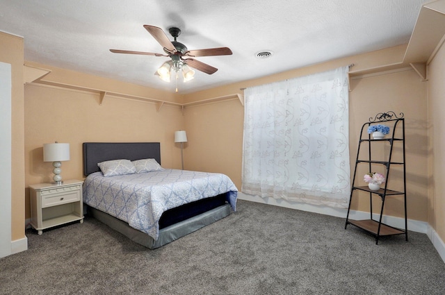 bedroom with carpet, visible vents, ceiling fan, a textured ceiling, and baseboards