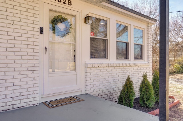 entrance to property with brick siding