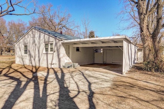 exterior space with a carport and driveway