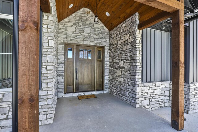 doorway to property with stone siding