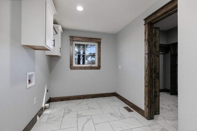 clothes washing area with washer hookup, marble finish floor, electric dryer hookup, and baseboards