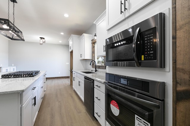 kitchen with stainless steel microwave, a sink, gas cooktop, oven, and dishwasher