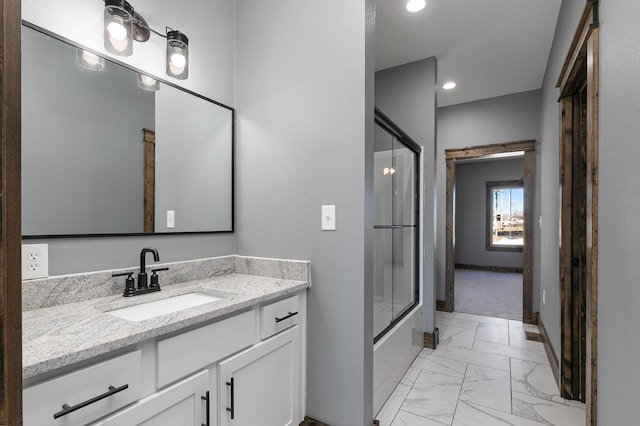 full bathroom with marble finish floor, recessed lighting, enclosed tub / shower combo, vanity, and baseboards